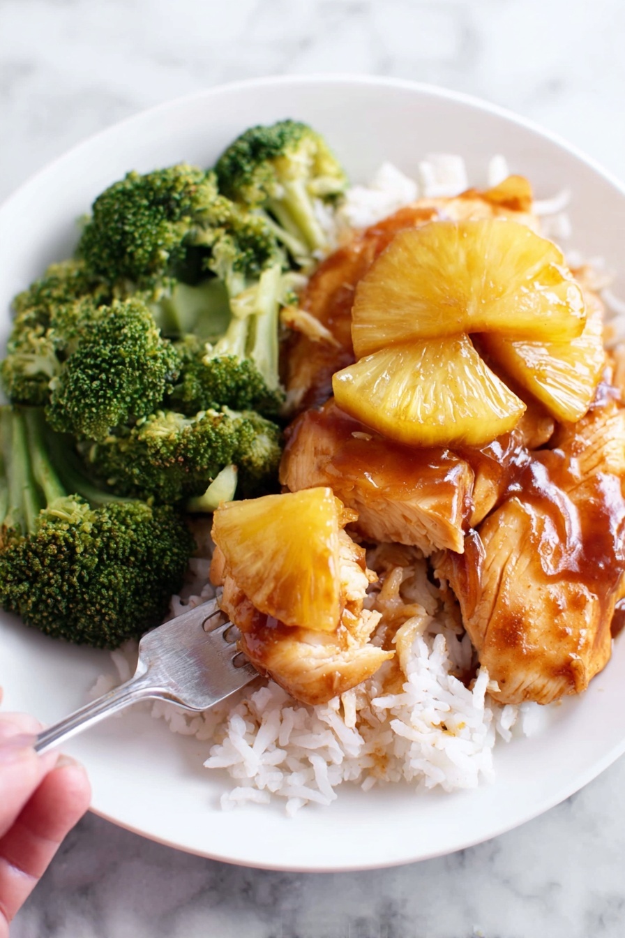 A white plate holds a meal with three main layers: a base layer of white rice spread out at the bottom, a middle layer of light golden cooked chicken pieces placed over the rice, and a top layer of shiny brown sauce with several slices of golden caramelized pineapple on the chicken. On one side of the plate, there is a pile of bright green broccoli. A fork is holding a small piece of chicken along with some sauce and pineapple slice close to the front left part of the image. The background is a white marbled surface. photo taken with an iphone --ar 2:3 --v 7