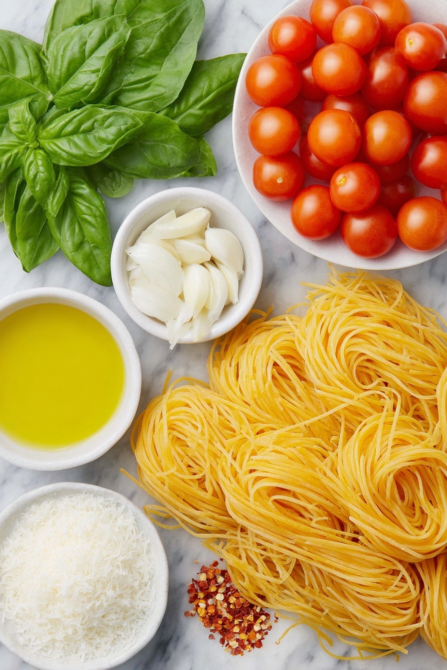 Flat lay of linguine pasta arranged neatly beside a small pile of halved cherry tomatoes, a fresh handful of vibrant baby spinach leaves, thinly sliced white onion rings fanned out, three whole uncracked brown garlic cloves, roughly chopped fresh basil leaves scattered artfully, a small white ceramic bowl filled with golden extra virgin olive oil, another small white bowl containing bright red crushed red pepper flakes, a third small white bowl holding fine white salt crystals, and a modest mound of freshly grated pale yellow parmesan cheese on a simple white ceramic plate, everything placed on a clean white marble surface, soft natural light, photo taken with an iPhone, professional food photography style, fresh ingredients, white ceramic bowls, no bottles, no duplicates, no utensils, no packaging --ar 2:3 --v 7 --p m7354615311229779997