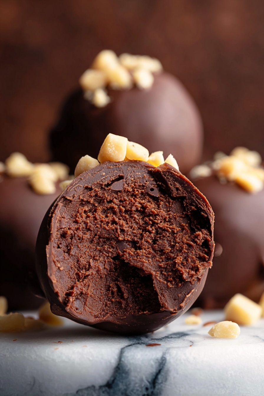 A white bowl holds seven round chocolate balls covered in dark smooth chocolate. Each ball is topped with small light brown chopped nuts, scattered unevenly on top. The balls are close together, filling the bowl, which sits on a white marbled textured surface. photo taken with an iphone --ar 2:3 --v 7